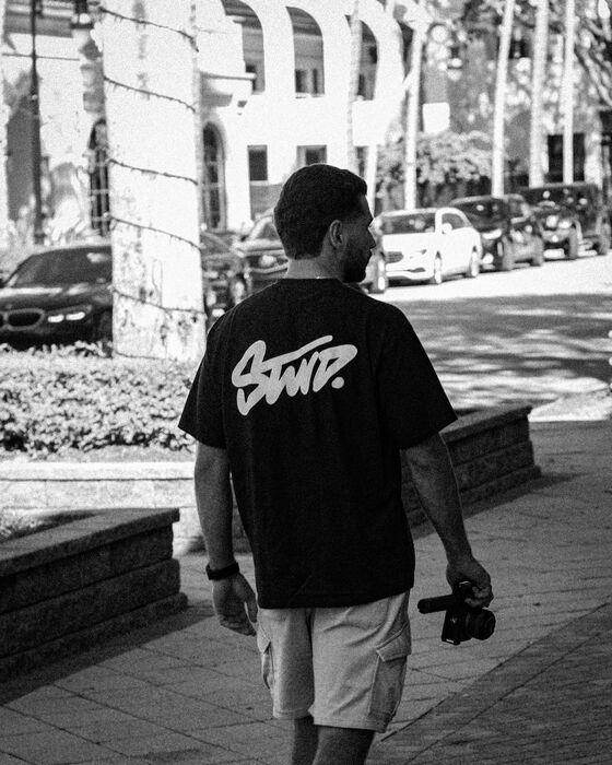 Founder walking with a camera between shoots